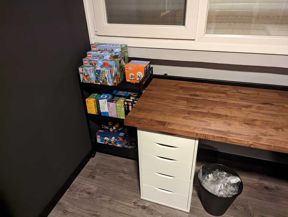Black trolley with 3 shelves filled with Lego boxes