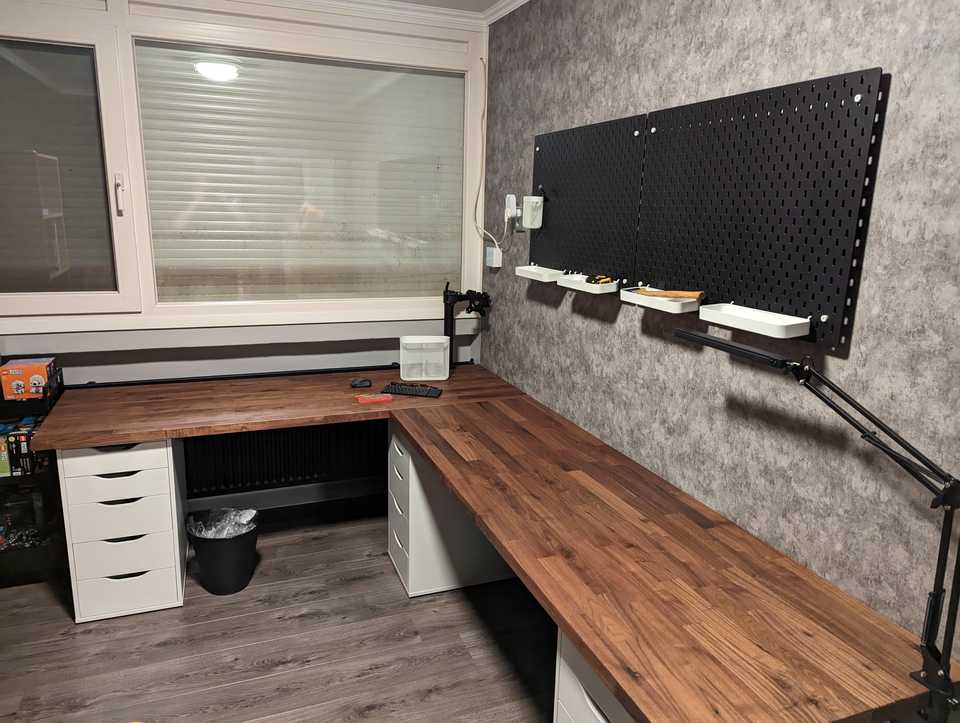 Dark walnut L-shaped corner desk with 3 white drawers holding it up